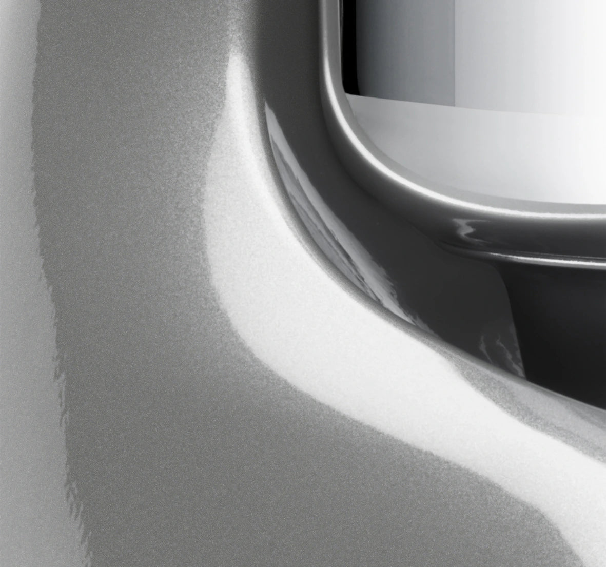 Close-up view of the Ankarsrum Assistent Original Stand Mixer in jubilee-silver (akm-6230-js, gloss-finish), highlighting its premium build, powerful motor, and unique mixing bowl design for efficient dough kneading.