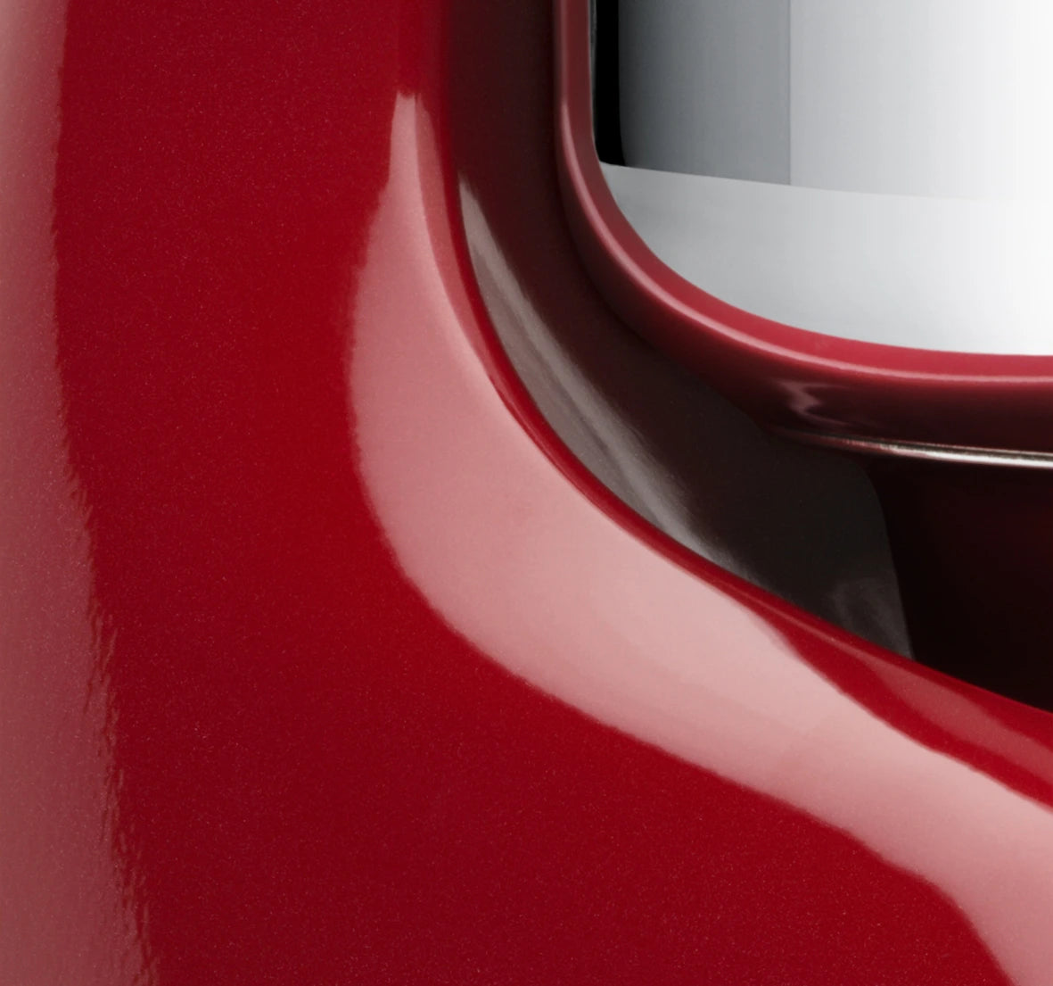 Close-up view of the Ankarsrum Assistent Original Stand Mixer in red (akm-6230-r, gloss-finish), highlighting its premium build, powerful motor, and unique mixing bowl design for efficient dough kneading.