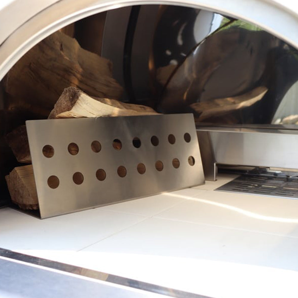 Interior view of the Pyro Kitchen Caldo V2 Hybrid Pizza Oven with log holder and thick cordierite pizza stones for perfect heat retention and distribution.