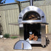 Front view of the Pyro Kitchen Vera V2 Wood Fired Pizza Oven with door open, showing logs stored under the oven in the spacious storage area.